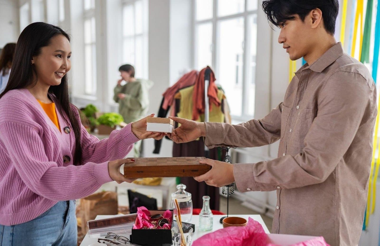 Two people exchanging goods at a market stall