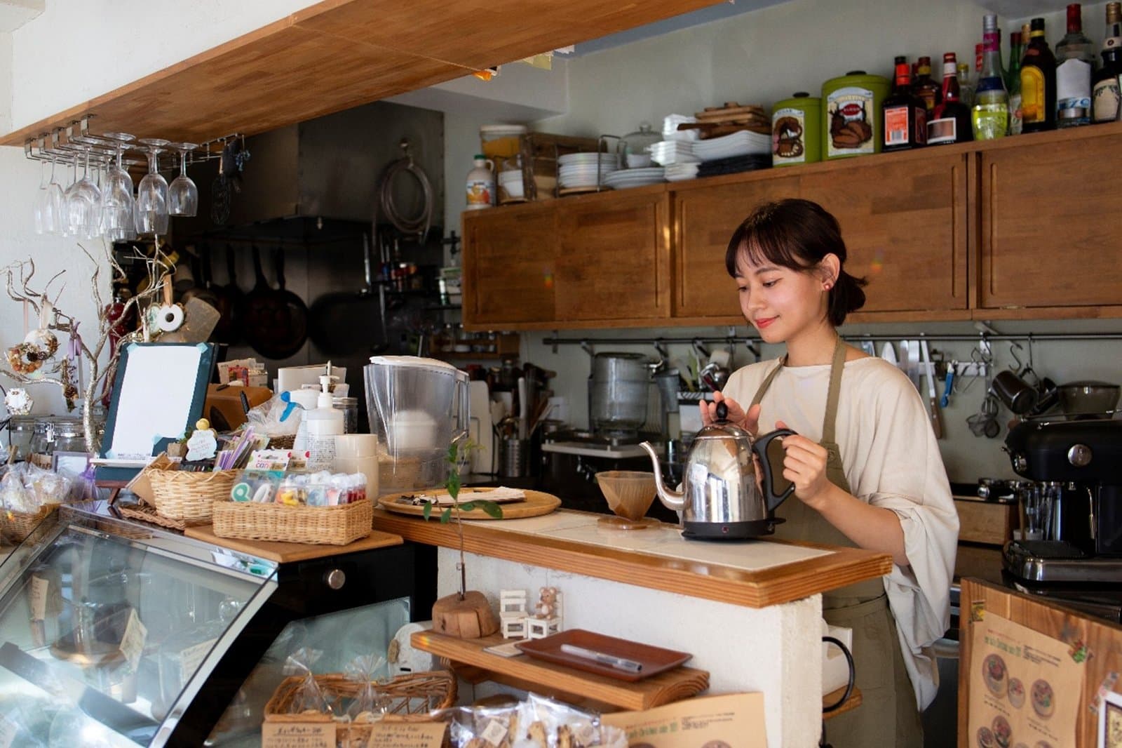 A small independent shop owner at work behind the counter