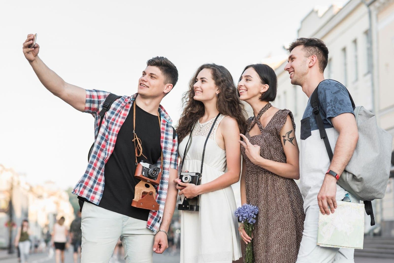 A group of foreign tourists taking a photo together on a city street