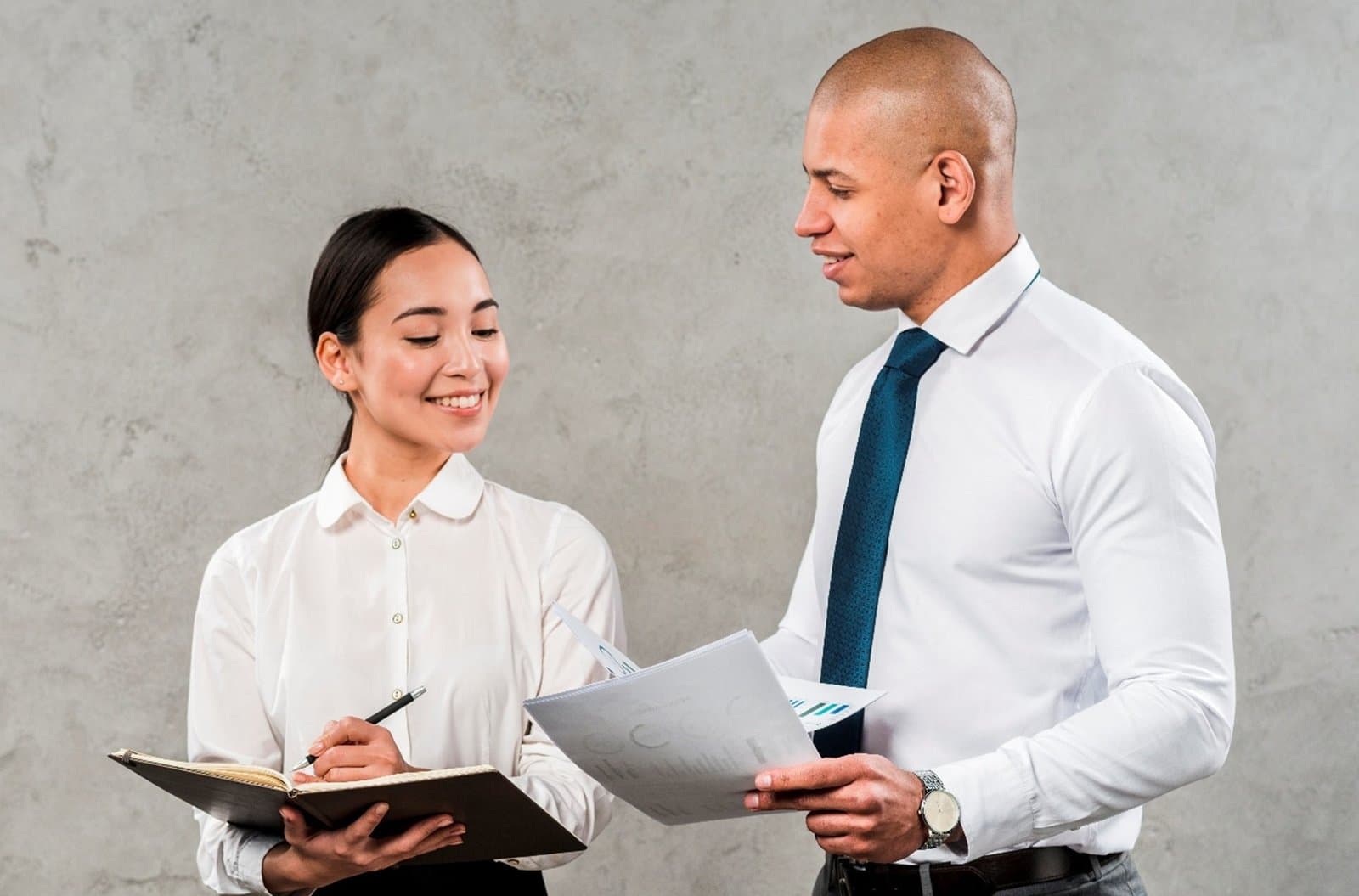 Two office colleagues reviewing paperwork together